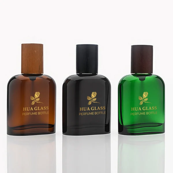 HUA0281 perfume bottle, rounded rectangular customizable semi-transparent glass body in amber, black, or green with thick base, 50 ml liquid, cylindrical cap in natural wood, dark brown wood, or black finish, gold printed logo on bottle surface, modern vintage luxury design, ideal for gifting and daily use.