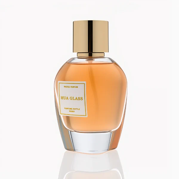 HUA0282 perfume bottle, rounded transparent glass body with thick clear base and customizable transparent colors, 100 ml liquid, glossy cylindrical Zamac cap in silver or gold finish with matching bottle neck, gold-bordered label attached on bottle surface, modern elegant luxury design, ideal for gifting and daily use.
