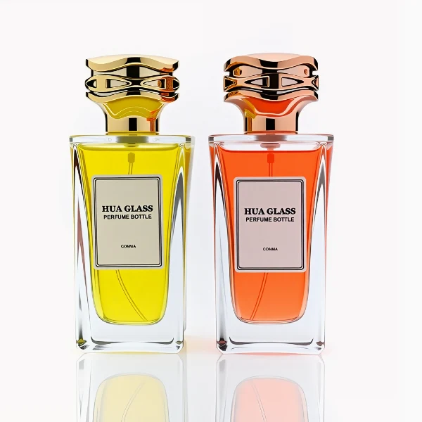HUA0284 perfume bottle, rectangular transparent colorless glass body with thick base and beveled edges, 100 ml liquid, cylindrical glossy plastic cap with wave-pattern side texture in gold or rose gold finish, printed label attached on bottle surface, modern luxurious fashion design, ideal for gifting and daily use.