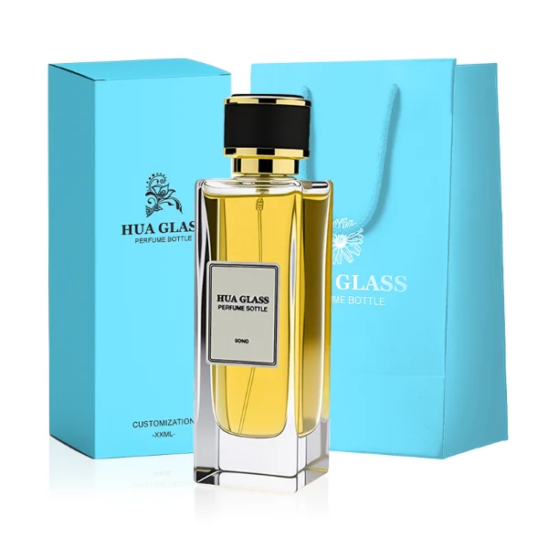 HUA0285 perfume bottle, tall rectangular transparent colorless glass body with thick base and flat sides, label attached on bottle surface, 100 ml liquid, cylindrical plastic cap with white or gold mesh-textured surface and gold or black rings on both ends, modern minimalist luxury design, ideal for gifting and daily use.