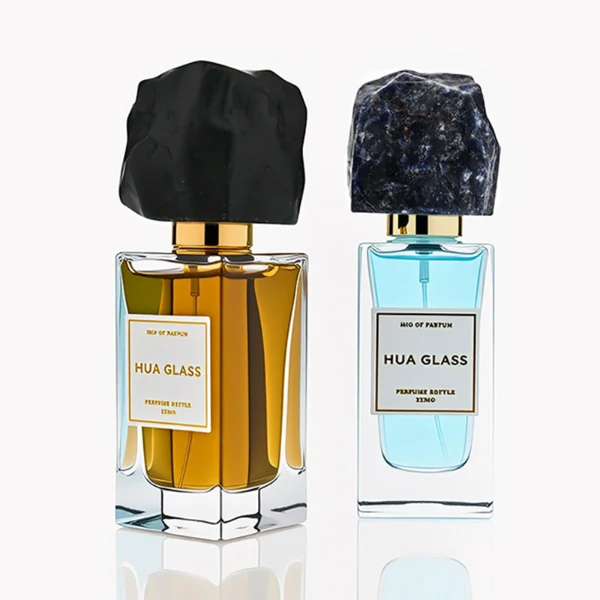HUA0286 perfume bottle, rectangular transparent colorless glass body with thick base and beveled edges, 30 ml, 50 ml, or 100 ml liquid, irregular natural stone cap with raw textured surface and gold bottle neck, printed label attached on bottle surface, modern artistic luxury design, ideal for gifting and daily use.