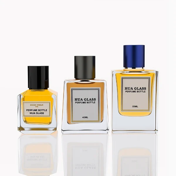 HUA0287 perfume bottle, transparent colorless glass body in cylindrical, rectangular, and ribbed shapes with thick base, 30 ml, 50 ml, or 100 ml liquid, glossy cylindrical aluminum magnetic cap in black, silver, or gold finish, printed label attached on bottle surface, modern minimalist luxury design, ideal for gifting and daily use.