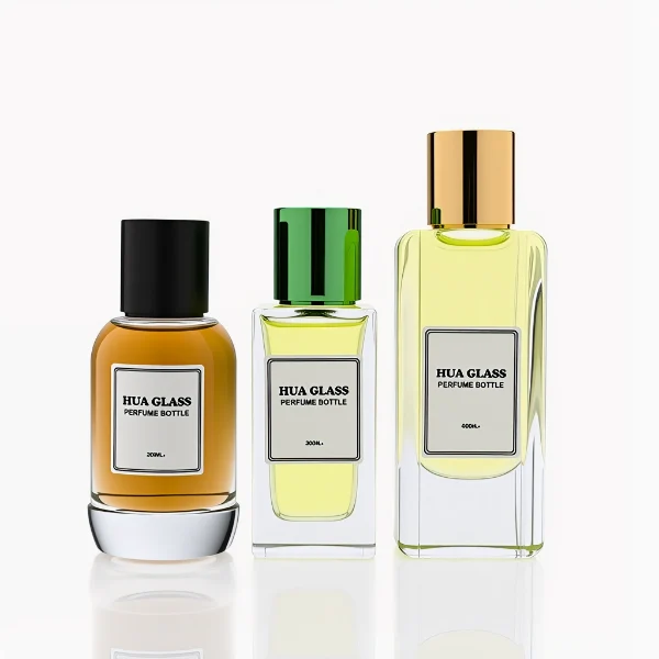HUA0287 perfume bottle, transparent colorless glass body in cylindrical, rectangular, and ribbed shapes with thick base, 30 ml, 50 ml, or 100 ml liquid, glossy cylindrical aluminum magnetic cap in black, silver, or gold finish, printed label attached on bottle surface, modern minimalist luxury design, ideal for gifting and daily use.