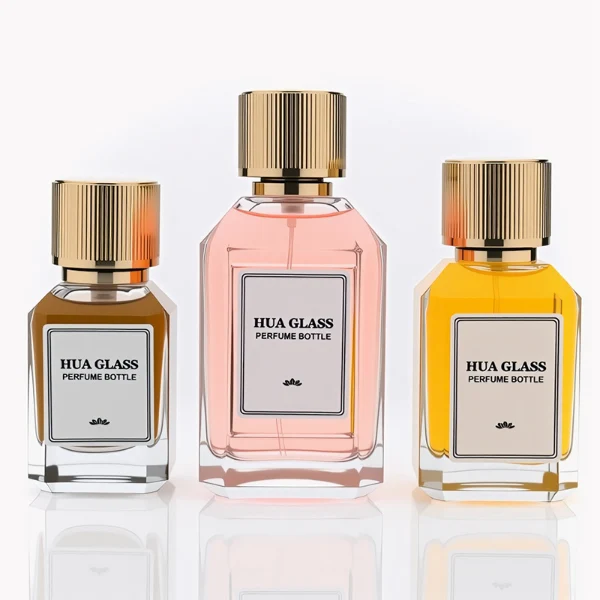 HUA0292 perfume bottle, transparent colorless octagonal beveled glass body with thick base and angled faceted edges, 30 ml, 50 ml, or 100 ml liquid, glossy gold cylindrical aluminum cap with matching gold bottle neck, printed label attached on bottle surface, modern elegant luxury design, ideal for gifting and daily use.