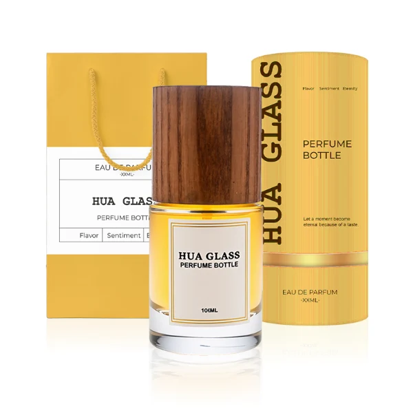HUA0296 perfume bottle, cylindrical transparent colorless glass body with thick base and smooth rounded silhouette, 30 ml, 50 ml, or 100 ml liquid, cylindrical wooden cap in natural wood or matte black finish, printed label attached on bottle surface, modern minimalist luxury design, ideal for gifting and daily use.