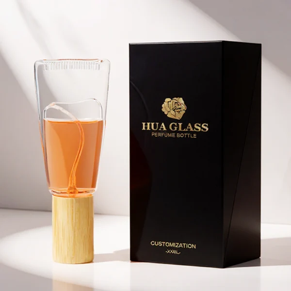 HUA0297 perfume bottle, transparent colorless cosmetic tube-inspired glass body with asymmetrical sculptural silhouette and bamboo base, 10 ml liquid, integrated natural bamboo cap, clean glass surface without logo printing, artistic modern minimalist design, ideal for travel and gifting.