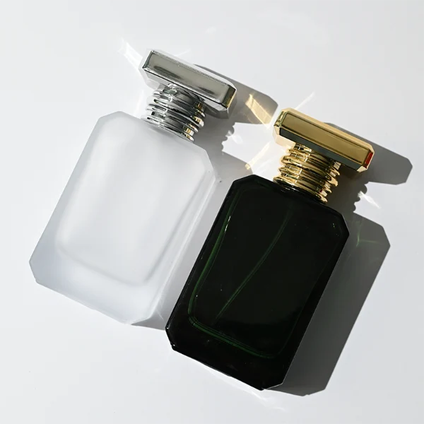 HUA0299 perfume bottle, frosted or semi-transparent customizable color glass body with geometric faceted edges and thick base, 30 ml, 50 ml, or 100 ml liquid, flat rectangular plastic cap in gold or silver color, printed logo on bottle surface, modern artistic luxury design, ideal for gifting and daily use.