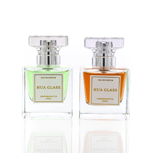 HUA0300 perfume bottle, rectangular transparent colorless glass body with thick base and smooth surface, 30 ml, 50 ml, or 100 ml liquid, flat multifaceted plastic cap with silver bottle neck, printed label attached on bottle surface, modern elegant luxury design, ideal for gifting and daily use.