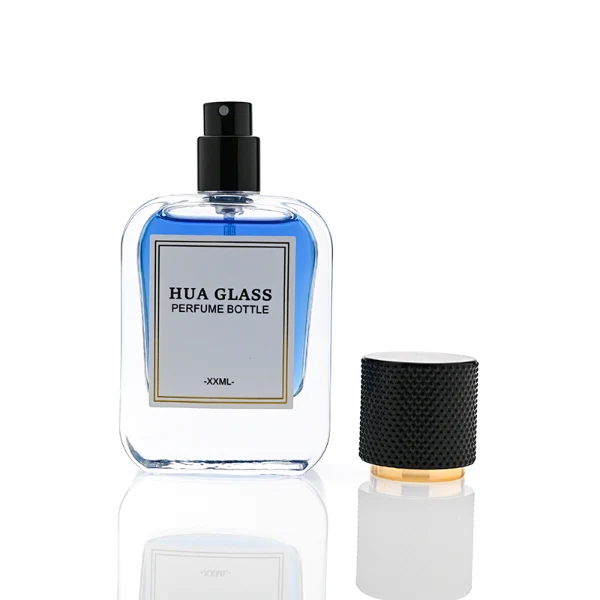 HUA0302 perfume bottle, rounded rectangular glass body with thick base in transparent, semi-transparent black, or amber color, 30 ml, 50 ml, or 100 ml liquid, cylindrical plastic cap with gold or silver bottle neck, printed logo or blank bottle surface, modern minimalist luxury design, ideal for gifting and daily use.
