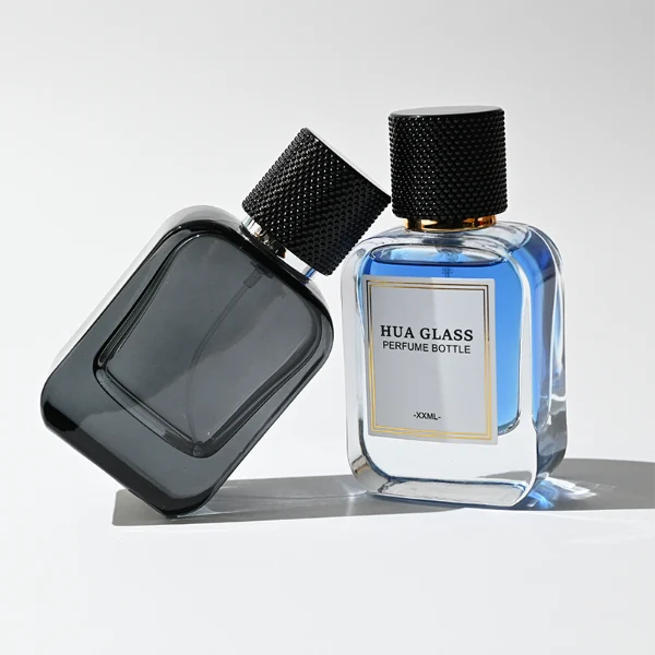 HUA0302 perfume bottle, rounded rectangular glass body with thick base in transparent, semi-transparent black, or amber color, 30 ml, 50 ml, or 100 ml liquid, cylindrical plastic cap with gold or silver bottle neck, printed logo or blank bottle surface, modern minimalist luxury design, ideal for gifting and daily use.