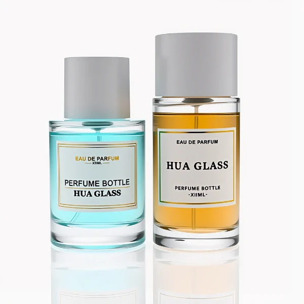 HUA0304 perfume bottle, cylindrical transparent colorless glass body with thick rounded base and smooth curved silhouette, 30 ml, 50 ml, or 100 ml liquid, glossy white cylindrical plastic cap with flat top, printed label attached on bottle surface, modern minimalist luxury design, ideal for gifting and daily use.