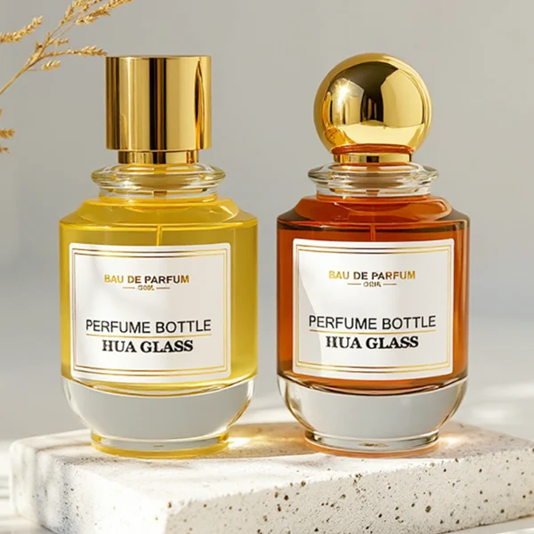 HUA0309 perfume bottle, rounded transparent colorless glass body with thick base and smooth curved silhouette, 100 ml liquid, glossy Zamac cap in cylindrical or spherical shape, printed label attached on bottle surface, elegant modern luxury design, ideal for gifting and daily use.