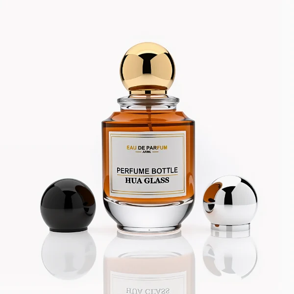 HUA0309 perfume bottle, rounded transparent colorless glass body with thick base and smooth curved silhouette, 100 ml liquid, glossy Zamac cap in cylindrical or spherical shape, printed label attached on bottle surface, elegant modern luxury design, ideal for gifting and daily use.
