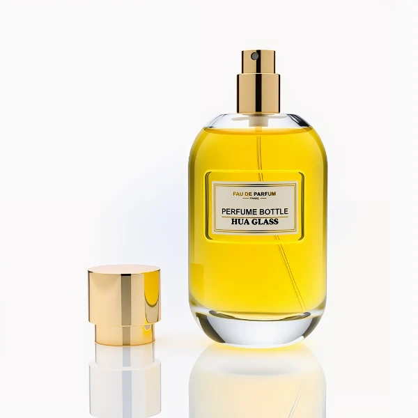 HUA0310 perfume bottle, rounded transparent colorless glass body with thick base and smooth curved silhouette, 100 ml liquid, glossy cylindrical Zamac cap with matching gold or silver metallic gloss bottle neck, printed label attached on bottle surface, modern minimalist luxury design, ideal for gifting and daily use.