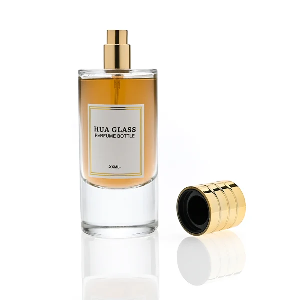 HUA0311 perfume bottle, cylindrical transparent colorless glass body with thick rounded base and smooth curved silhouette, 80 ml liquid, layered cylindrical plastic cap with ring groove details in gold or black finish, printed label attached on bottle surface, modern minimalist luxury design, ideal for gifting and daily use.