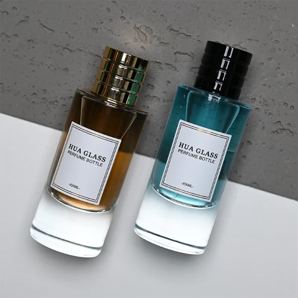 HUA0311 perfume bottle, cylindrical transparent colorless glass body with thick rounded base and smooth curved silhouette, 80 ml liquid, layered cylindrical plastic cap with ring groove details in gold or black finish, printed label attached on bottle surface, modern minimalist luxury design, ideal for gifting and daily use.