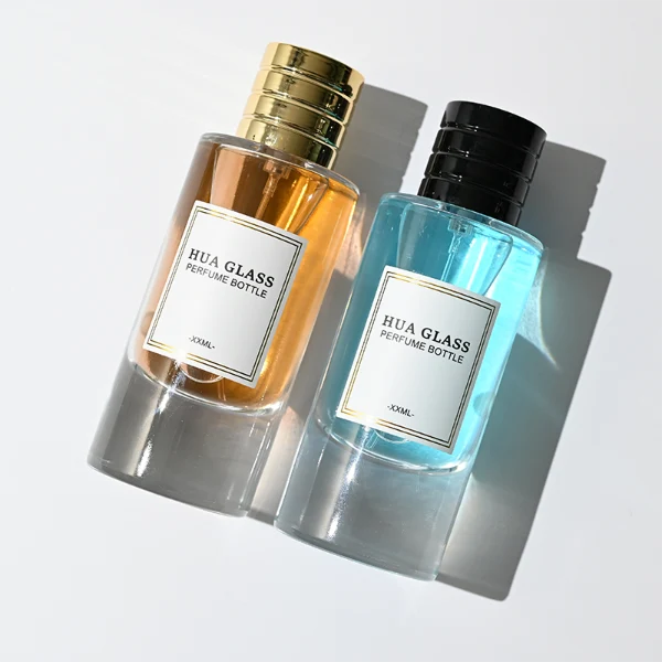 HUA0311 perfume bottle, cylindrical transparent colorless glass body with thick rounded base and smooth curved silhouette, 80 ml liquid, layered cylindrical plastic cap with ring groove details in gold or black finish, printed label attached on bottle surface, modern minimalist luxury design, ideal for gifting and daily use.