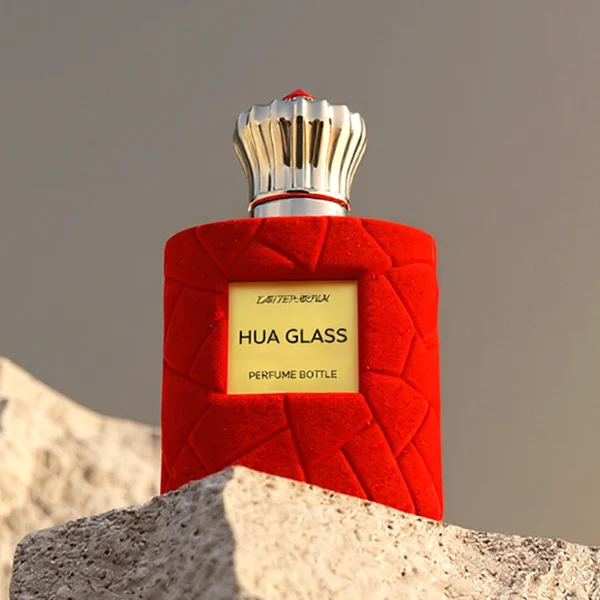 HUA0313 perfume bottle, cylindrical velvet-textured glass body in red or black color, 50 ml or 100 ml liquid, circular Zamac cap with sunburst texture and gemstone detail, aluminum labelsticker attached on bottle surface, artistic luxury vintage design, ideal for gifting and daily use.