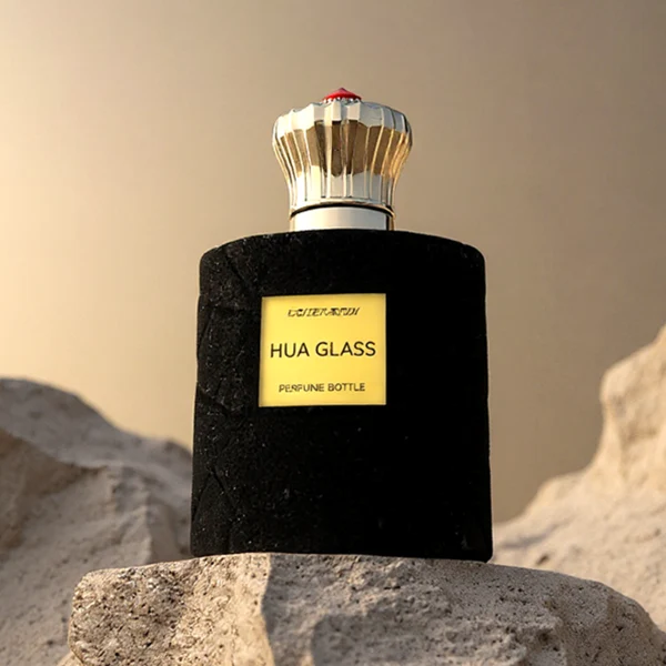 HUA0313 perfume bottle, cylindrical velvet-textured glass body in red or black color, 50 ml or 100 ml liquid, circular Zamac cap with sunburst texture and gemstone detail, aluminum labelsticker attached on bottle surface, artistic luxury vintage design, ideal for gifting and daily use.