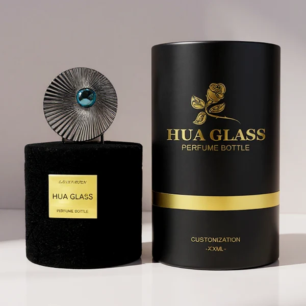 HUA0313 perfume bottle, cylindrical velvet-textured glass body in red or black color, 50 ml or 100 ml liquid, circular Zamac cap with sunburst texture and gemstone detail, aluminum labelsticker attached on bottle surface, artistic luxury vintage design, ideal for gifting and daily use.