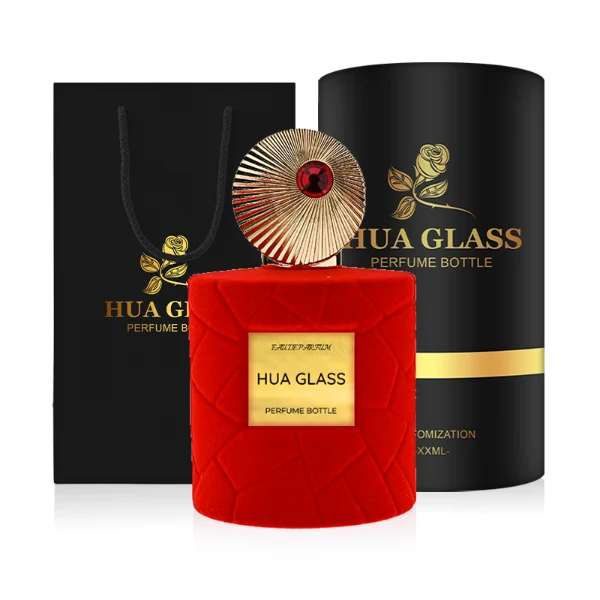 HUA0313 perfume bottle, cylindrical velvet-textured glass body in red or black color, 50 ml or 100 ml liquid, circular Zamac cap with sunburst texture and gemstone detail, aluminum labelsticker attached on bottle surface, artistic luxury vintage design, ideal for gifting and daily use.