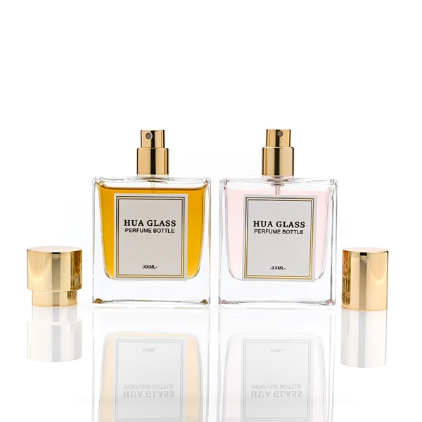 HUA0316 perfume bottle, square transparent colorless glass body with thick base and sharp edges, 30 ml, 50 ml, or 100 ml liquid, straight cylindrical Zinc Alloy cap or cylindrical cap with glossy gold bottle neck, printed label attached on bottle surface, modern minimalist luxury design, ideal for gifting and daily use.