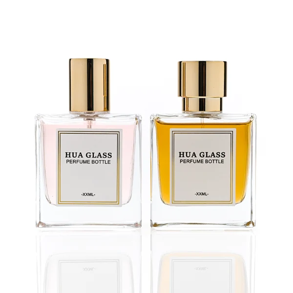 HUA0316 perfume bottle, square transparent colorless glass body with thick base and sharp edges, 30 ml, 50 ml, or 100 ml liquid, straight cylindrical Zinc Alloy cap or cylindrical cap with glossy gold bottle neck, printed label attached on bottle surface, modern minimalist luxury design, ideal for gifting and daily use.