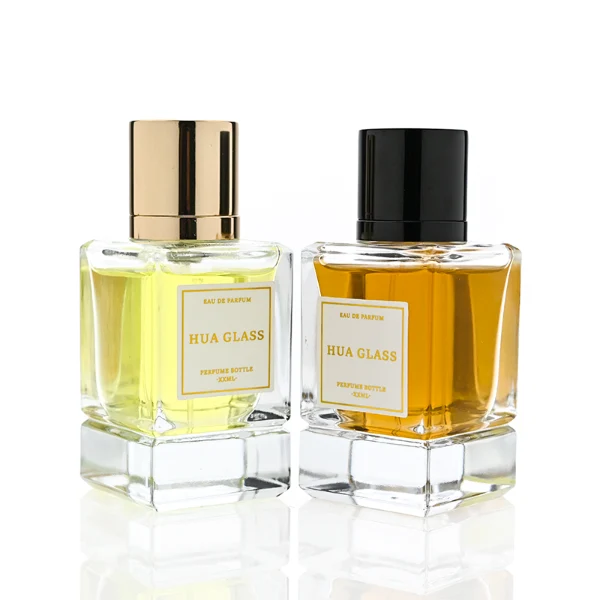 HUA0318 perfume bottle, rectangular transparent colorless glass body with thick base and sharp edges, 30 ml, 50 ml, or 100 ml liquid, glossy cylindrical aluminum cap in gold or black finish, printed label attached on bottle surface, modern minimalist luxury design, ideal for gifting and daily use.