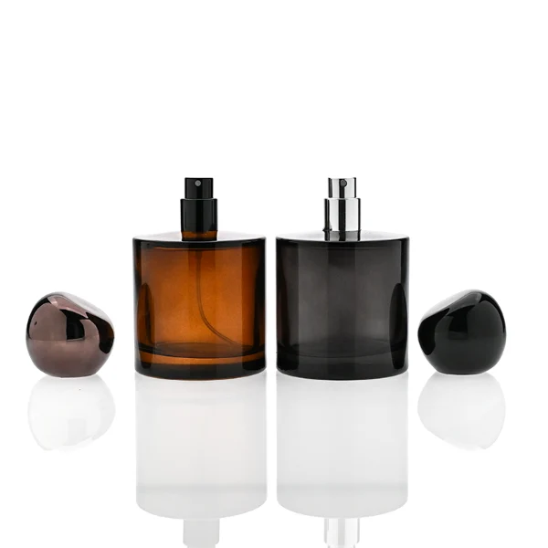 HUA0321 perfume bottle, cylindrical semi-transparent amber or black glass body with thick rounded base, 30 ml, 50 ml, or 100 ml liquid, glossy spherical plastic cap in black or dark purple color, clean blank bottle design, modern artistic minimalist style, ideal for gifting and daily use.