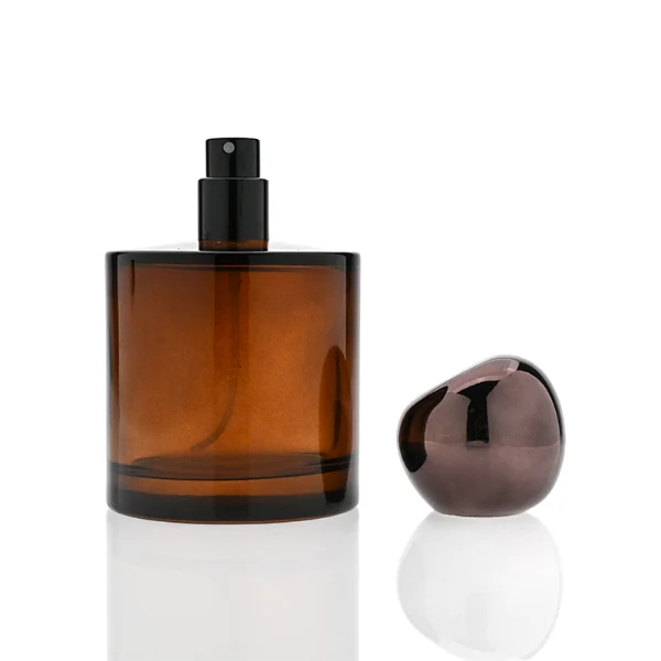 HUA0321 perfume bottle, cylindrical semi-transparent amber or black glass body with thick rounded base, 30 ml, 50 ml, or 100 ml liquid, glossy spherical plastic cap in black or dark purple color, clean blank bottle design, modern artistic minimalist style, ideal for gifting and daily use.