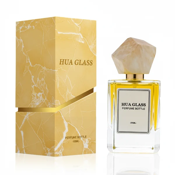 HUA0322 perfume bottle, square transparent colorless glass body with thick base and sharp edges, 30 ml, 50 ml, or 100 ml liquid, irregular geometric stone-inspired plastic cap in beige or marble white color with gold or silver bottle neck, printed label attached on bottle surface, artistic modern luxury design, ideal for gifting and daily use.