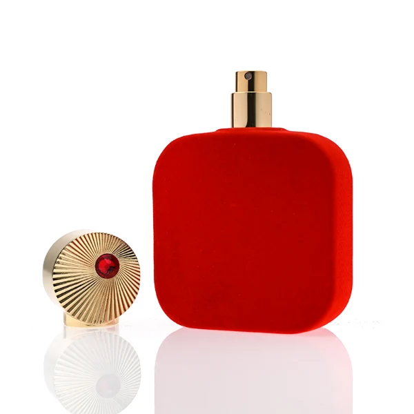 HUA0323 perfume bottle, rounded rectangular matte red or matte black glass body with thick base, 30 ml, 50 ml, or 100 ml liquid, decorative Zamac cap with engraved radial texture or crown-inspired design and jewel detail, aluminum label/sticker attached on bottle surface, artistic luxury vintage style, ideal for gifting and display.