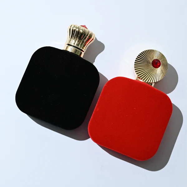 HUA0323 perfume bottle, rounded rectangular matte red or matte black glass body with thick base, 30 ml, 50 ml, or 100 ml liquid, decorative Zamac cap with engraved radial texture or crown-inspired design and jewel detail, aluminum label/sticker attached on bottle surface, artistic luxury vintage style, ideal for gifting and display.