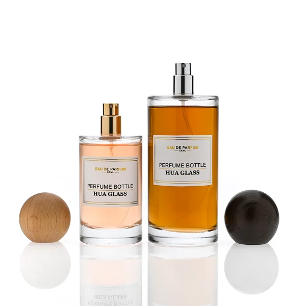 HUA0325 perfume bottle, cylindrical transparent colorless glass body with thick rounded base and smooth silhouette, 30 ml, 50 ml, 100 ml, 200 ml, or 250 ml liquid, spherical wooden cap with natural wood grain texture in light or dark finish, printed label attached on bottle surface, natural modern minimalist design, ideal for gifting and display.