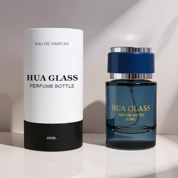 HUA0326 perfume bottle, rounded cylindrical semi-transparent smoky black, amber brown, or blue glass body with thick base, 30 ml, 50 ml, or 100 ml liquid, layered cylindrical plastic cap with black, white, or blue center section and glossy gold or silver accents on both ends, optional metallic gold printed logo or blank bottle surface, modern minimalist luxury design, ideal for gifting and daily use.