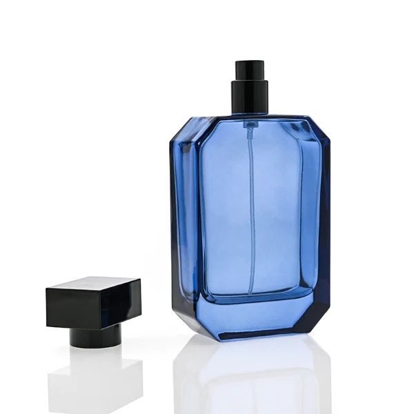 HUA0328 perfume bottle, rounded cylindrical semi-transparent amber or smoky black glass body with soft curved corners and thick base, 100 ml liquid, cylindrical leather-wrapped plastic cap with glossy gold top detail and matching gold bottle neck, clean blank bottle surface, modern minimalist luxury design, ideal for gifting and daily use.