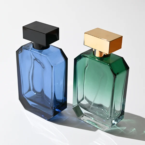 HUA0329 perfume bottle, multifaceted semi-transparent gradient green, blue, or red glass body with beveled polyhedral cutting and clear base, 30 ml, 50 ml, or 100 ml liquid, wide rectangular silver plastic cap with matching silver bottle neck, gold printed logo on bottle surface, modern geometric luxury design, ideal for gifting and daily use.