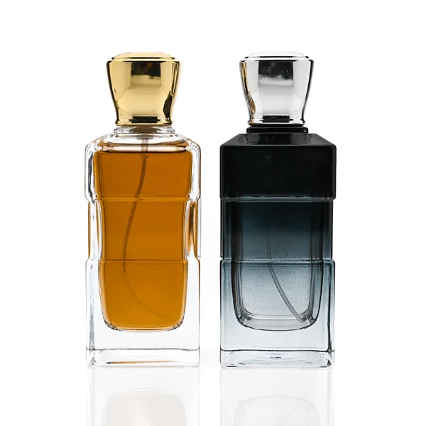 HUA0332 perfume bottle, rectangular semi-transparent gradient black or transparent colorless glass body with smooth curved edges and thick base, 100 ml liquid, rounded square-shaped glossy plastic cap in gold or silver finish, brand logo label attached on bottle surface, modern geometric luxury design, ideal for gifting and daily use.