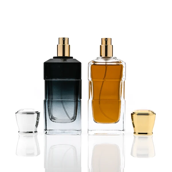 HUA0332 perfume bottle, rectangular semi-transparent gradient black or transparent colorless glass body with smooth curved edges and thick base, 100 ml liquid, rounded square-shaped glossy plastic cap in gold or silver finish, brand logo label attached on bottle surface, modern geometric luxury design, ideal for gifting and daily use.