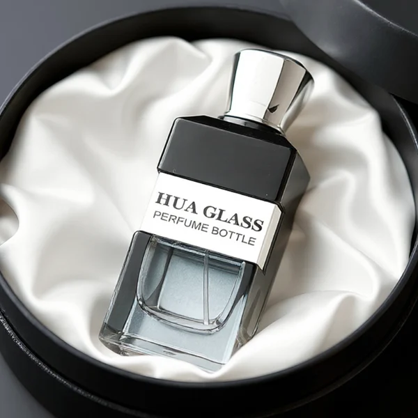 HUA0332 perfume bottle, rectangular semi-transparent gradient black or transparent colorless glass body with smooth curved edges and thick base, 100 ml liquid, rounded square-shaped glossy plastic cap in gold or silver finish, brand logo label attached on bottle surface, modern geometric luxury design, ideal for gifting and daily use.