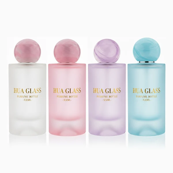 HUA0333 perfume bottle, rounded cylindrical frosted glass body in white, pink, lavender, or light blue, 30 ml, 50 ml, or 100 ml liquid, spherical resin cap with marble-inspired texture, silver bottle neck, gold printed brand logo on bottle surface, modern pastel luxury design, ideal for gifting and daily use.