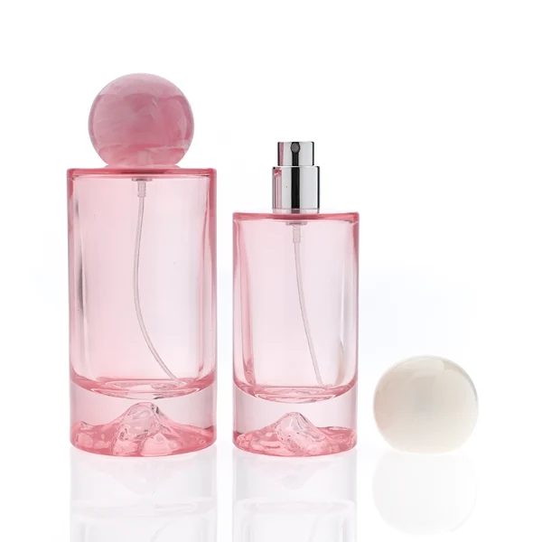 HUA0333 perfume bottle, rounded cylindrical frosted glass body in white, pink, lavender, or light blue, 30 ml, 50 ml, or 100 ml liquid, spherical resin cap with marble-inspired texture, silver bottle neck, gold printed brand logo on bottle surface, modern pastel luxury design, ideal for gifting and daily use.