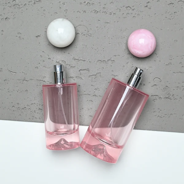 HUA0333 perfume bottle, rounded cylindrical frosted glass body in white, pink, lavender, or light blue, 30 ml, 50 ml, or 100 ml liquid, spherical resin cap with marble-inspired texture, silver bottle neck, gold printed brand logo on bottle surface, modern pastel luxury design, ideal for gifting and daily use.