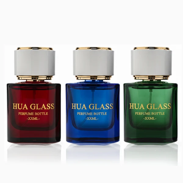 HUA0335 perfume bottle, cylindrical semi-transparent red, blue, or green glass body with thick base, 30 ml, 50 ml, or 100 ml liquid, cylindrical plastic cap with flat top and metal decorative rings on both ends, gold bottle neck, gold printed brand logo on bottle surface, modern minimalist luxury design, ideal for gifting and daily use.