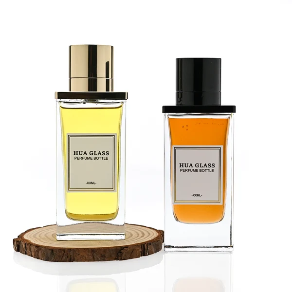 HUA0336 perfume bottle, rectangular transparent colorless glass body with thick base, 100 ml liquid, T-shaped aluminum and magnetic cap with cylindrical upper structure and horizontal flat top in black or gold finish, label attached on bottle surface, modern minimalist luxury design, ideal for gifting and daily use.