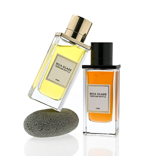 HUA0336 perfume bottle, rectangular transparent colorless glass body with thick base, 100 ml liquid, T-shaped aluminum and magnetic cap with cylindrical upper structure and horizontal flat top in black or gold finish, label attached on bottle surface, modern minimalist luxury design, ideal for gifting and daily use.
