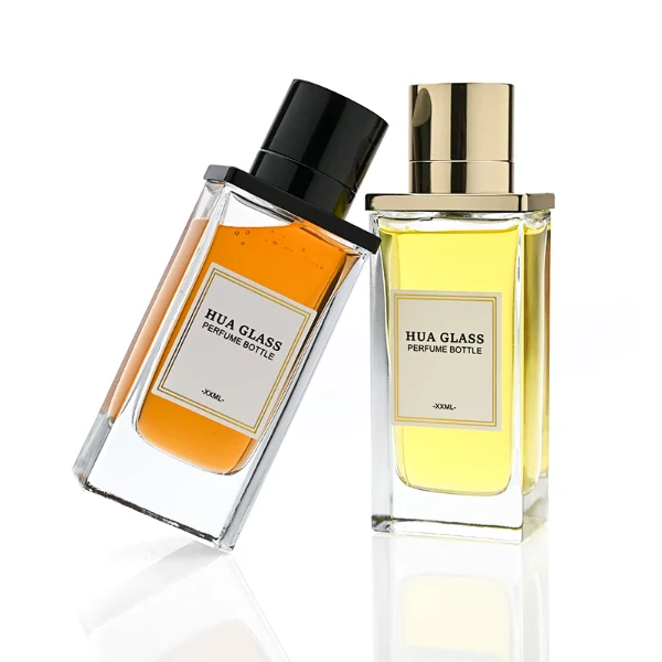 HUA0336 perfume bottle, rectangular transparent colorless glass body with thick base, 100 ml liquid, T-shaped aluminum and magnetic cap with cylindrical upper structure and horizontal flat top in black or gold finish, label attached on bottle surface, modern minimalist luxury design, ideal for gifting and daily use.