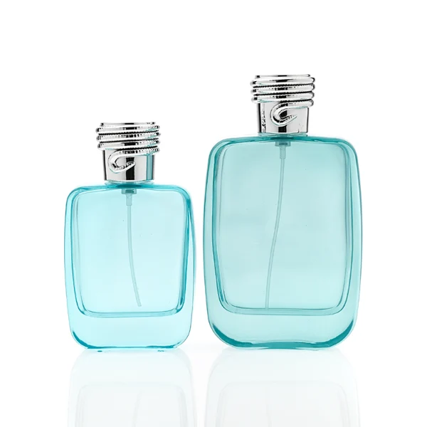 HUA0337 perfume bottle, rounded rectangular transparent colorless glass body with light blue tint, 50 ml or 100 ml liquid, silver cylindrical plastic cap with rope-inspired decorative detail, silver bottle neck, gold printed brand logo on bottle surface, modern minimalist luxury design, ideal for gifting and daily use.