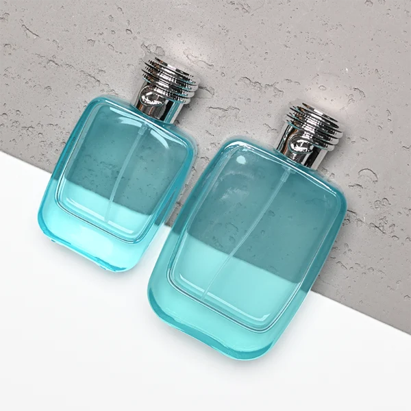 HUA0337 perfume bottle, rounded rectangular transparent colorless glass body with light blue tint, 50 ml or 100 ml liquid, silver cylindrical plastic cap with rope-inspired decorative detail, silver bottle neck, gold printed brand logo on bottle surface, modern minimalist luxury design, ideal for gifting and daily use.