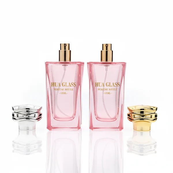HUA0338 perfume bottle, rectangular transparent pink glass body with curved inner contour and thick base, 100 ml liquid, irregular geometric plastic cap with wave-pattern side texture in gold or silver finish, matching metallic bottle neck, clean bottle surface for logo printing or label application, elegant feminine luxury design, ideal for gifting and daily use.
